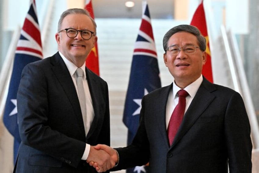 Prime Minister Anthony Albanese (L) shakes hands with Premier Li Qiang, the highest-rankin