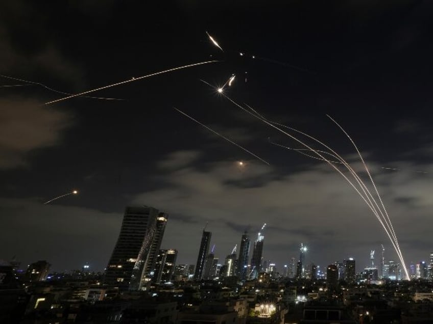 The Israeli Iron Dome air defense system fires to intercept missiles during an Iranian att