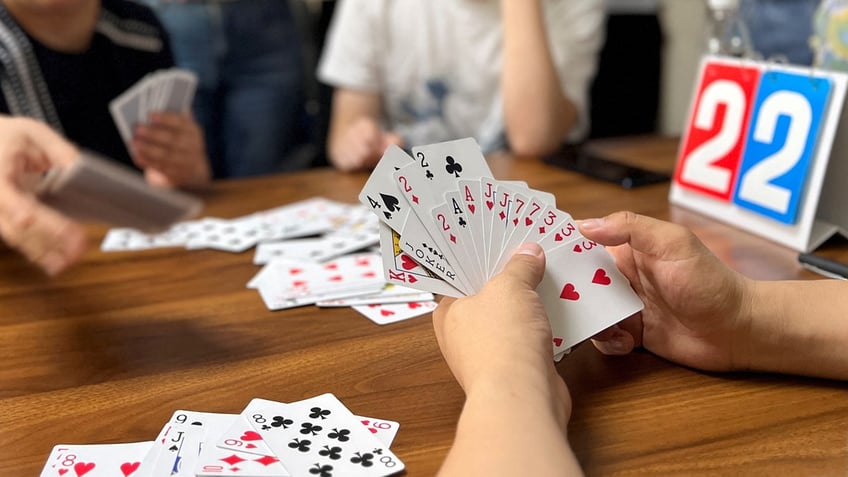 chinas financial players turn to guandan card game amidst shifting investment landscape