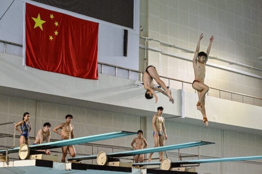 At Muxiyuan sports centre, home to Beijing's top diving school, young divers jumped, twist