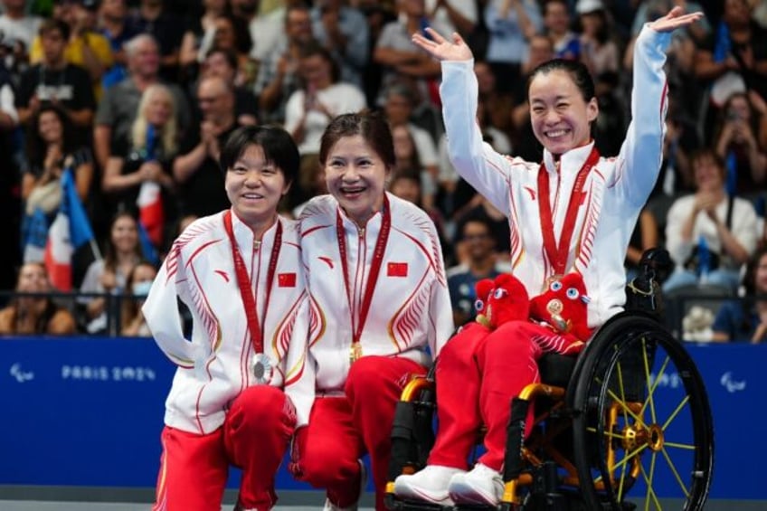 Chinese Paralympians He Shenggao (silver), gold medallist Lu Dong and Liu Yu (bronze) cele