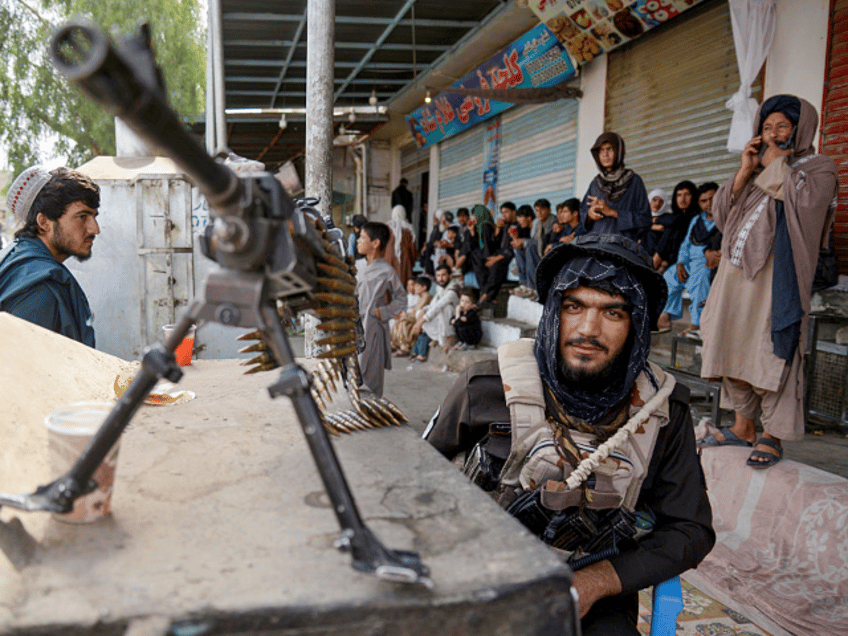 TOPSHOT - An armed Taliban Security personnel keeps guard during a religious procession by