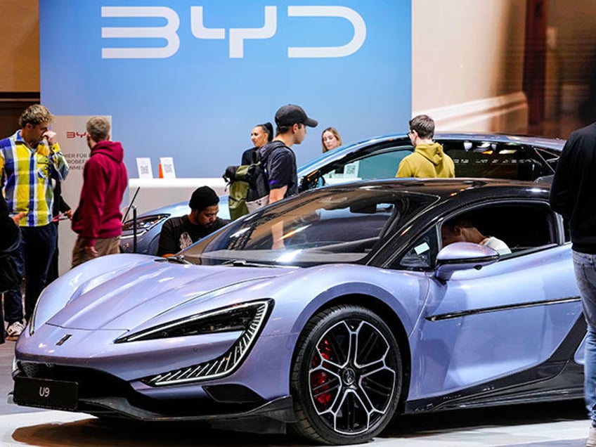 People visit the exhibition of Chinese electric car maker BYD at the Essen Motor Show in E