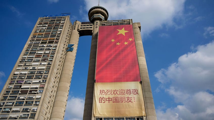 A giant Chinese national flag is installed on a skyscraper that is a symbolic gateway leading into the Belgrade, Serbia, from the airport.