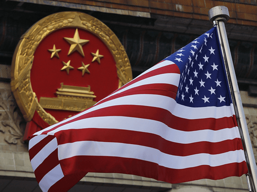 In this Nov. 9, 2017, file photo, an American flag is flown next to the Chinese national emblem during a welcome ceremony for visiting U.S. U.S. officials are issuing new warnings about China’s ambitions in artificial intelligence and a range of advanced technologies that could eventually give Beijing a decisive military edge and possible dominance over health care and other essential sectors in America. (AP Photo/Andy Wong, File)