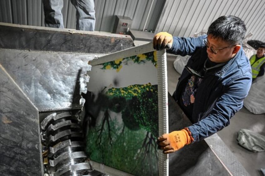 At a dusty warehouse in China shreds photos of beaming bridal couples turning stories of h