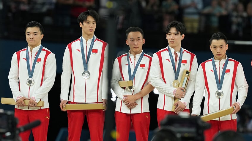 Chinese gymnastics team stands at the podium