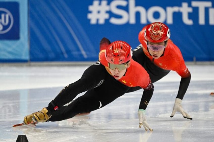 China's Lin Xiaojun (L) and Sun Long compete in the 500m quarter-finals in Beijing