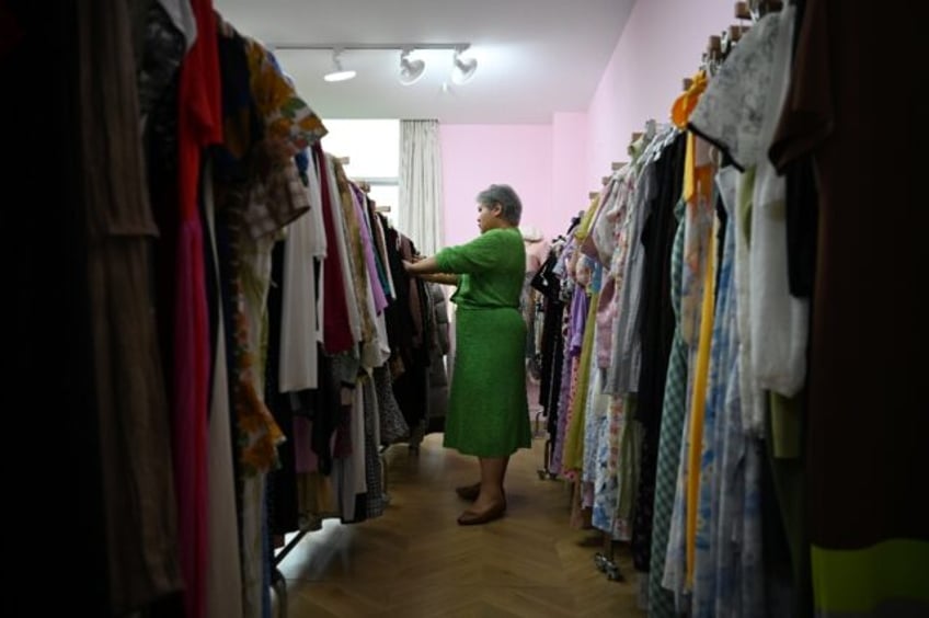 Plus-size clothing brand owner and influencer Amanda Yao inspects clothes in her office in