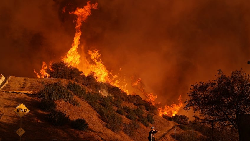 firefighter battles the Palisades Fire