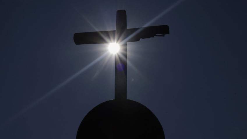 A cross stands outside a church in Culhuacan in Mexico City, Mexico, on December 26, 2024, during the celebration of the patron saint San Juan Evangelista. (Photo by Gerardo Vieyra/NurPhoto via Getty Images)