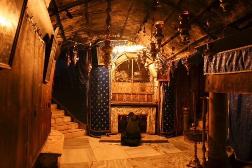 A solitary visitor prays in the grotto believed to be the spot where Jesus was born