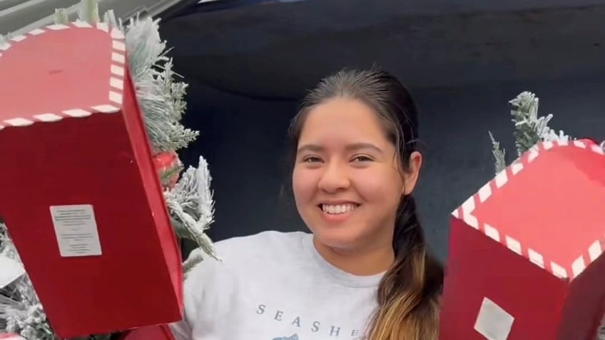 woman saves money by dumpster diving for holiday decor