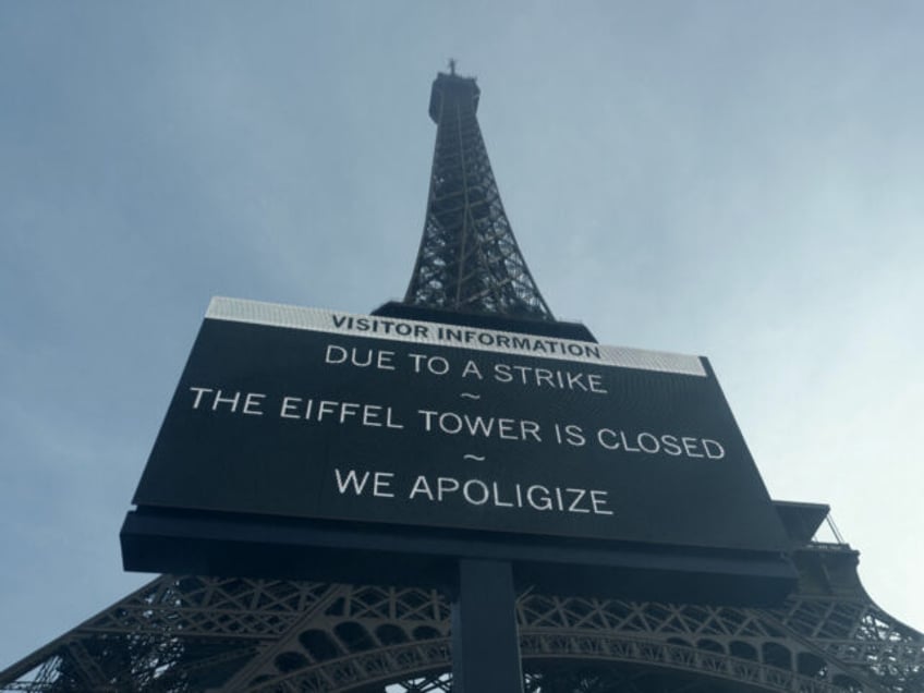 This photograph taken on December 27, 2023 shows a board informing visitors that the site is closed after staff went on strike, at the bottom of the Eiffel Tower in Paris. The strike on the 100th anniversary of the death of engineer Gustave Eiffel, who built the tower, was to …