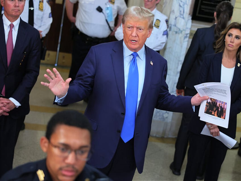 NEW YORK, NEW YORK - OCTOBER 02: Former US President Donald Trump holds a printout as he s