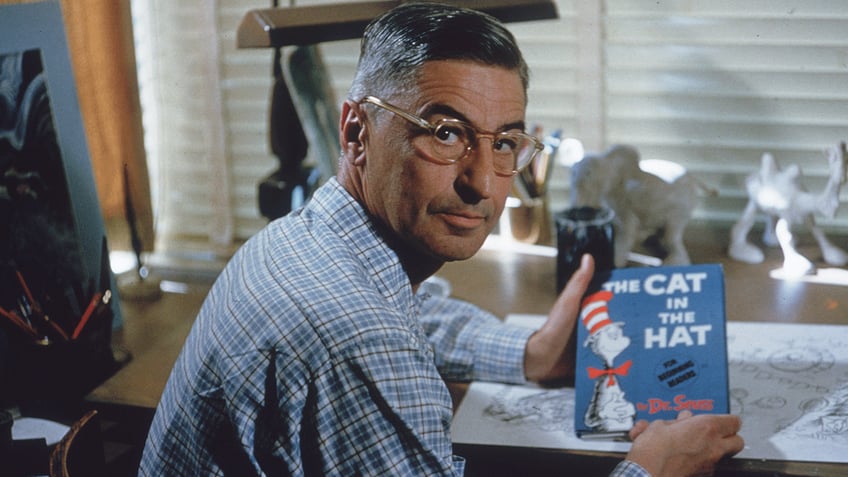 Dr. Seuss holding "The Cat in the Hat"