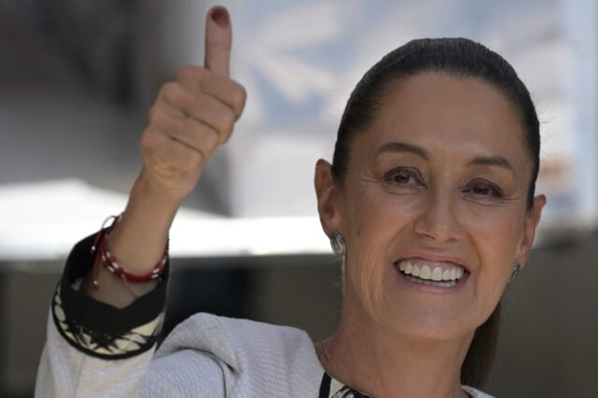 Mexican ruling party presidential candidate Claudia Sheinbaum shows her inked finger as sh