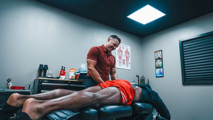 Denzel Ward receiving treatment from Dr. Chad