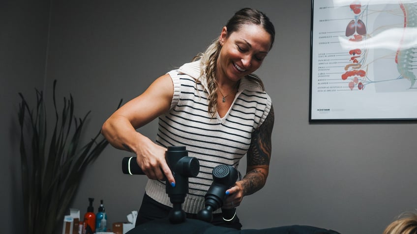 Dr. Mary treating patient at Code Chiro