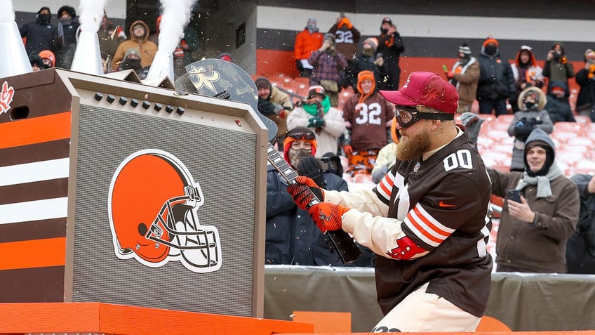 Dawg Pound Captain Jake Paul smashes a New Orleans Saints custom guitar over a Cleveland Browns amp prior to the National Football League game between the New Orleans Saints and Cleveland Browns on December 24, 2022, at FirstEnergy Stadium in Cleveland, OH. 