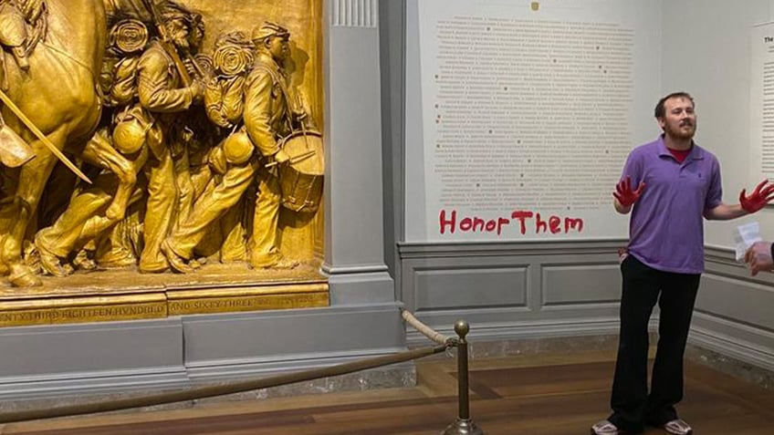 climate activist smears red paint on washington dc civil war exhibit honoring black soldiers