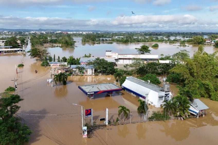 Climate change fuelled a rare string of typhoons that battered the Philippines this year a