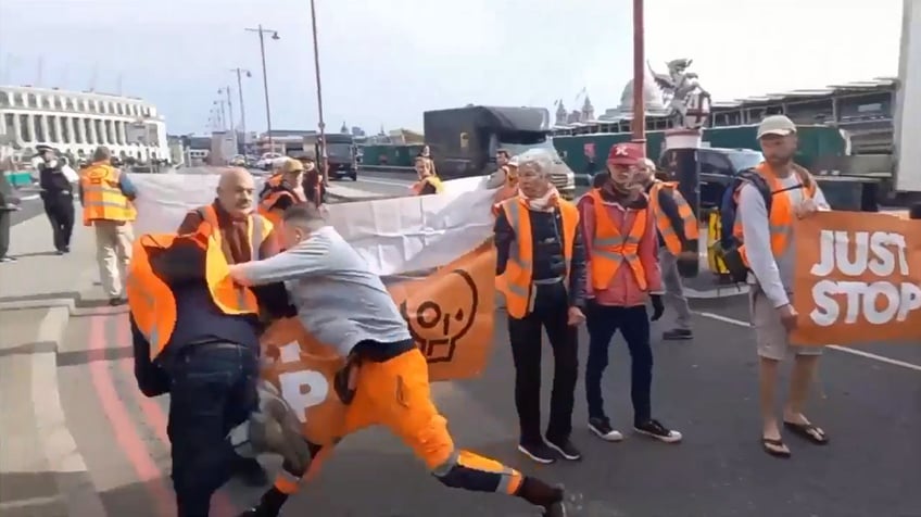 climate protester blocking road shoved to the ground after pregnant womans car crashes