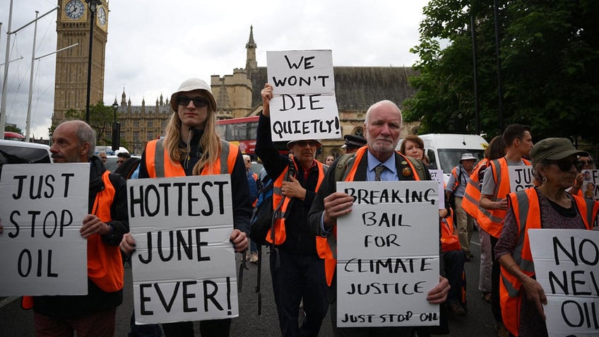 climate protester blocking road shoved to the ground after pregnant womans car crashes