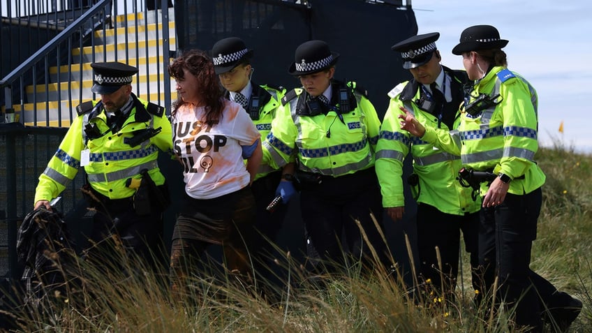 climate protestors disrupt open championship with orange substance on 17th green horschel forced to intervene