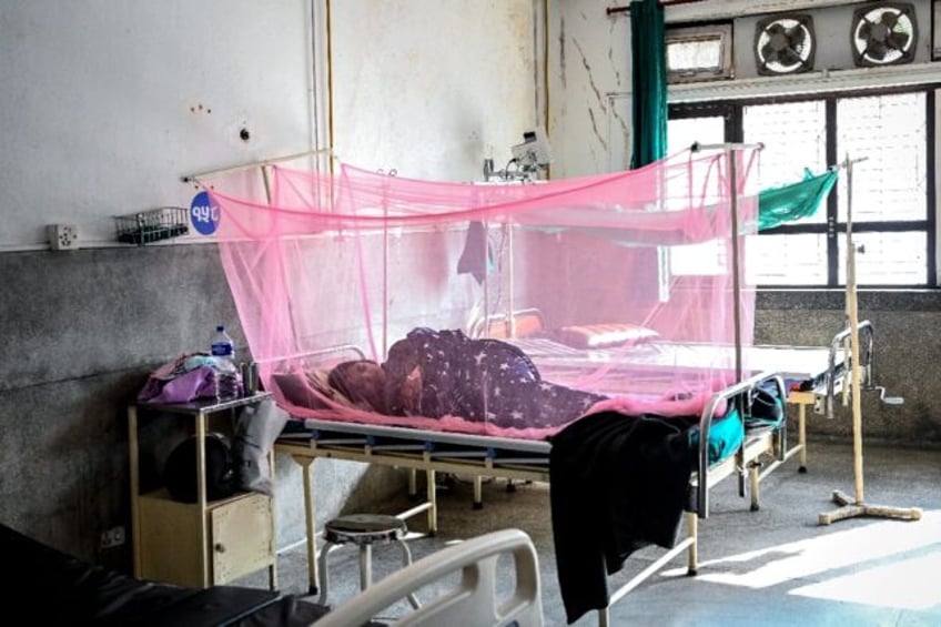 A patient undergoes treatment for dengue in Nepal, where more than 28,000 have been infect