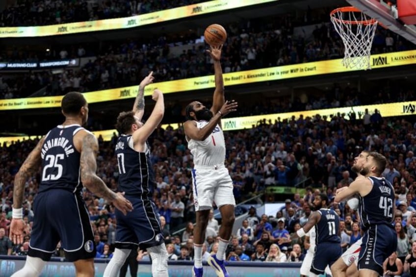 James Harden of the Los Angeles Clippers shoots the ball while defended by Luka Doncic in