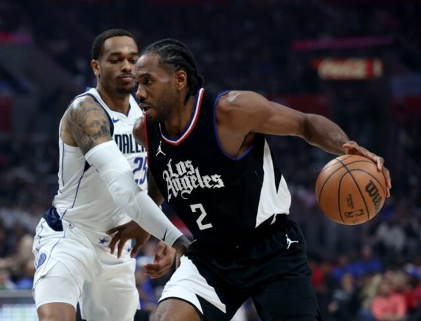 Los Angeles Clippers forward Kawhi Leonard, dribbling past P.J. Washington of Dallas, will