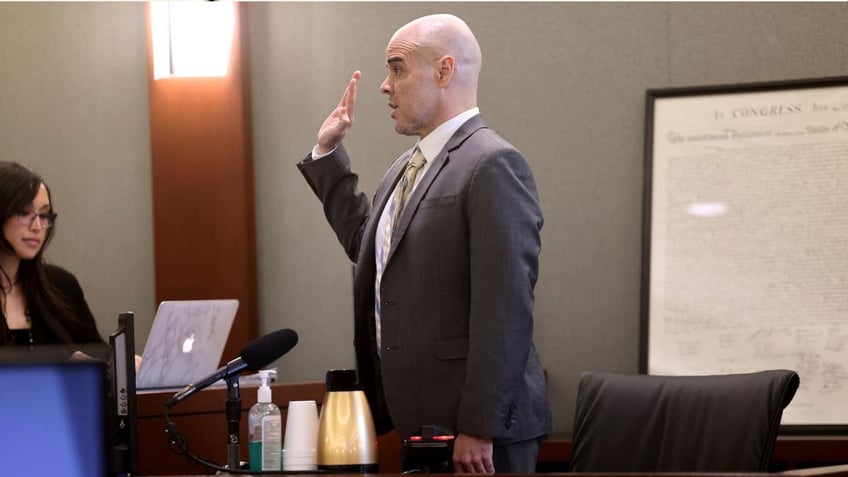 Robert Telles raises his right hand in court