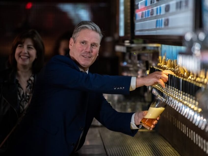 LONDON, ENGLAND - JULY 06: Labour Party leader, Sir Keir Starmer, pulls a pint of beer wit