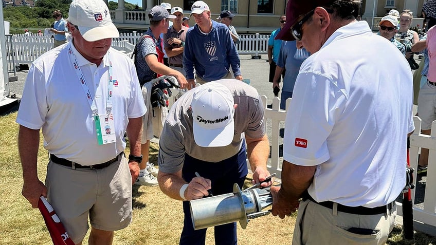 Frank Bensel signs the hole cutter