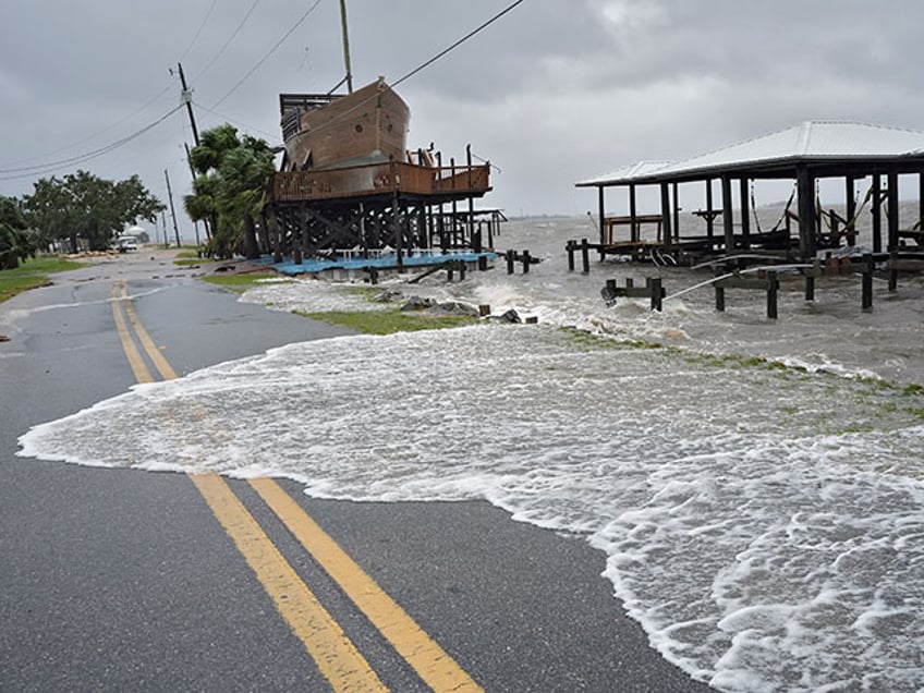 Storm surge breaks over a small sea wall near boat docks, Monday, Aug. 5, 2024, in Horseshoe Beach, Fla. Hurricane Debby made landfall early this morning.(AP Photo/Christopher O'Meara)