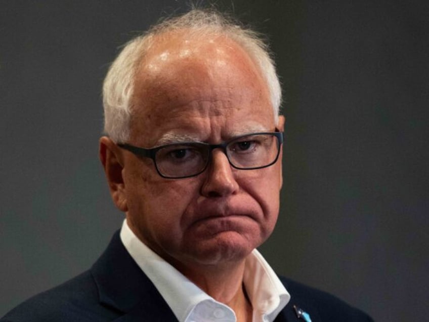 BLOOMINGTON, MINNESOTA - AUGUST 1: Minnesota Governor Tim Walz (R) listens during a press