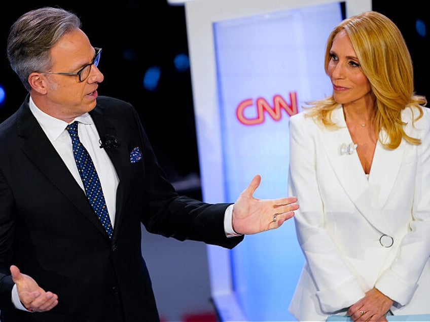 FILE - CNN anchors Jake Tapper, left, and Dana Bash, right, speaking to members of the aud