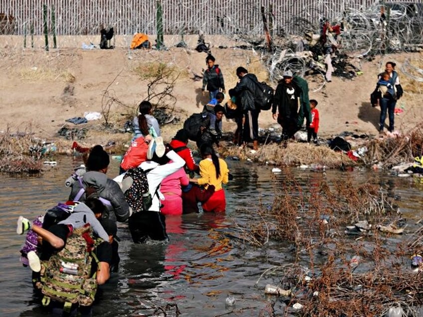 Migrants cross the Rio Bravo river, known as Rio Grande in the United States, into the US through Ciudad Juarez, Chihuahua State, Mexico, on January 2, 2024. US border police have in recent weeks reported approximately 10,000 crossings by migrants every day, many of them fleeing poverty and violence in …