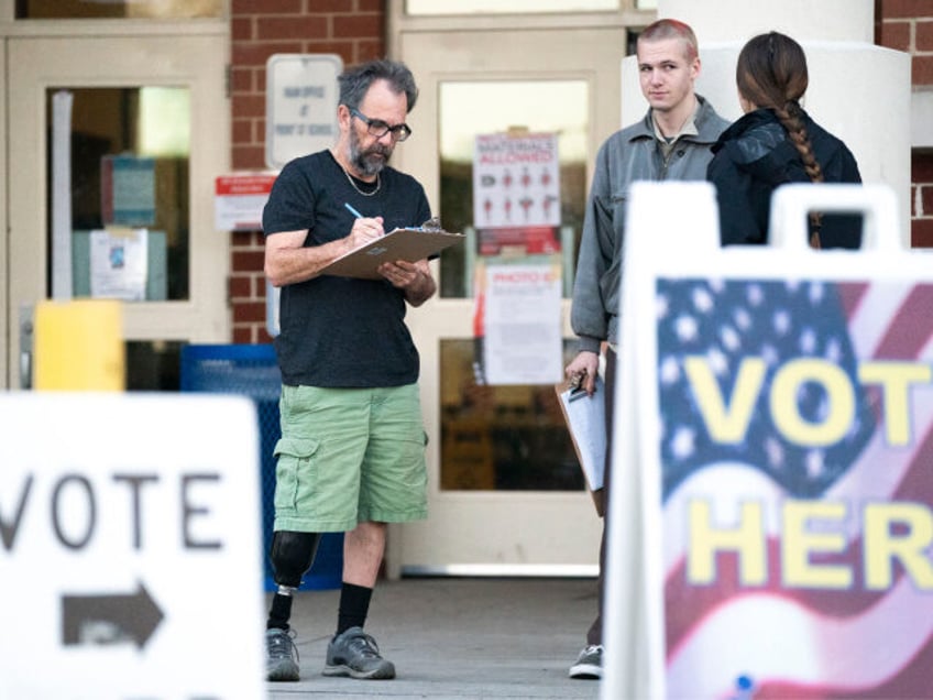 A man participates in exit polling after voting in the South Carolina Republican president