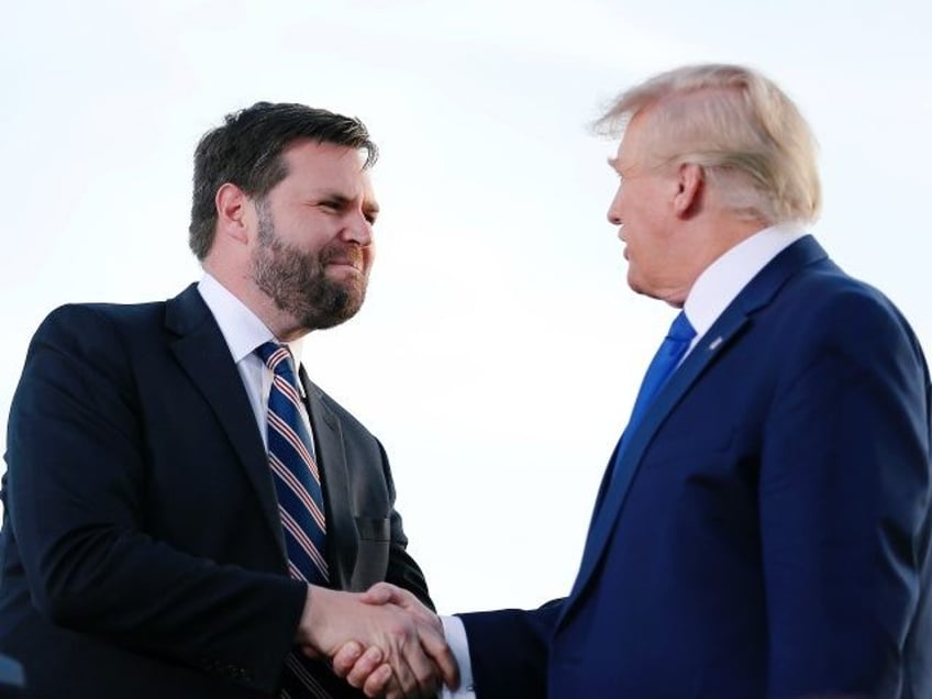 FILE - Senate candidate JD Vance, left, greets former President Donald Trump at a rally at