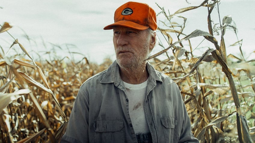 Close up of Craig T. Nelson in a cornfield