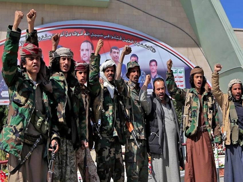 Fighters loyal to Yemen's Huthi rebels raise their fists and chant slogans as they visit the grave of slain Huthi political leader Saleh al-Sammad at al-Sabeen square in the capital Sanaa, on January 11, 2021. - In April 2018, al-Sammad, who was on the Saudi-led coalition's wanted list, was killed in what the insurgents said was an air strike by the coalition. (Photo by Mohammed HUWAIS / AFP) (Photo by MOHAMMED HUWAIS/AFP via Getty Images)