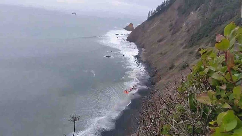 helicopter hovering over remote beach