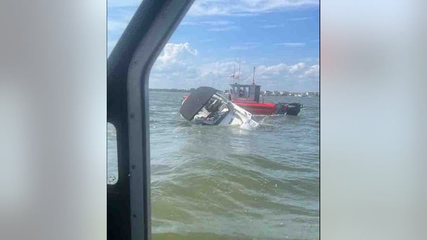 coast guard saves 4 people dog from sinking boat moments before it capsizes