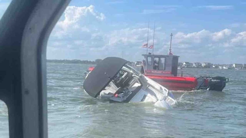 coast guard saves 4 people dog from sinking boat moments before it capsizes