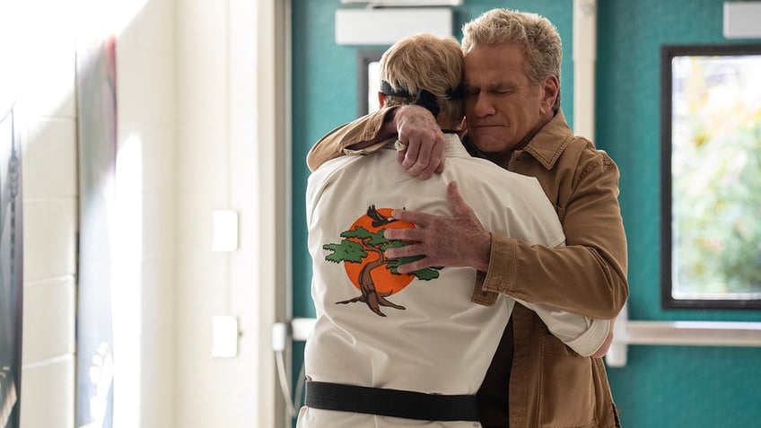 Martin Kove hugging William Zabka in a scene from "Cobra Kai"