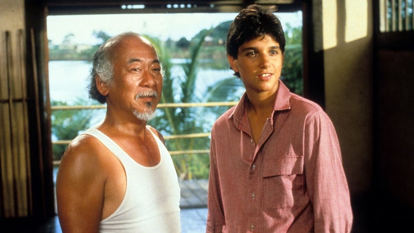 Pat Morita and Ralph Macchio in a scene from The Karate Kid