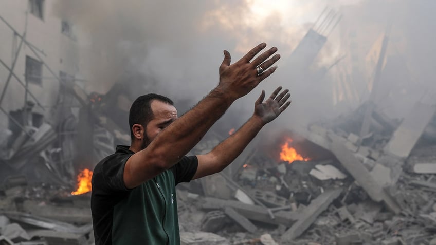 Man with arms raised in Gaza