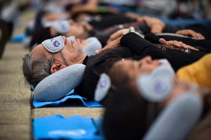 Around 200 people take part in a collective siesta in Mexico City to mark World Sleep Day